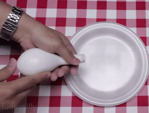 the person is touching an egg on a plate