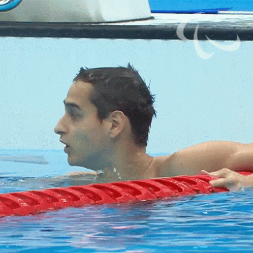 a man swimming in an empty pool in a swim suit