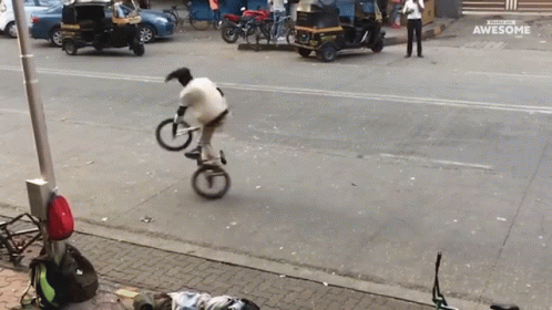 a man is riding a bike on the sidewalk