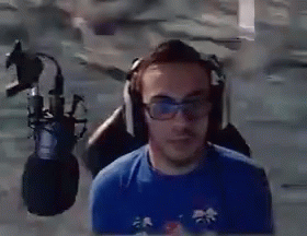 a man wearing headphones is seen through the window