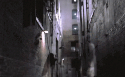 an alley way with a person walking down one side