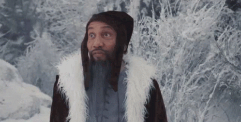 an avatar wearing a long fur vest next to a wooded area