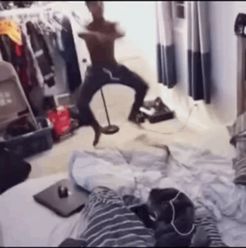 woman dancing while on bed with another person