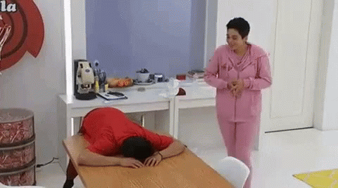 two women are seen in the mirror while a lady lays down