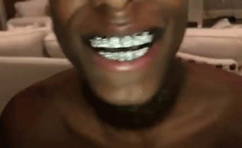 this is an image of a man wearing a fake smile