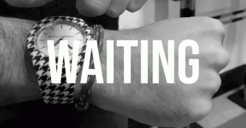 someone wearing a watch in their wrist that says waiting
