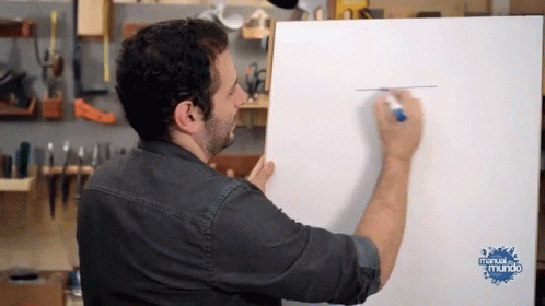 a man is drawing on a piece of paper