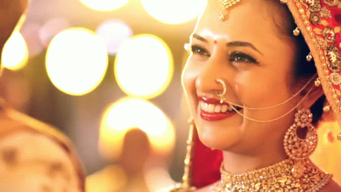 a woman wearing a headpiece is smiling
