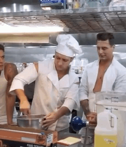 a group of men working in a kitchen together