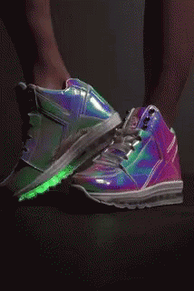 feet with glowing neon shoes on