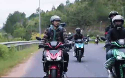 four people on motorcycles are in a race