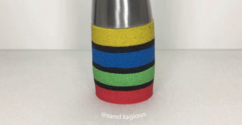 a multicolored vase with handle on a table