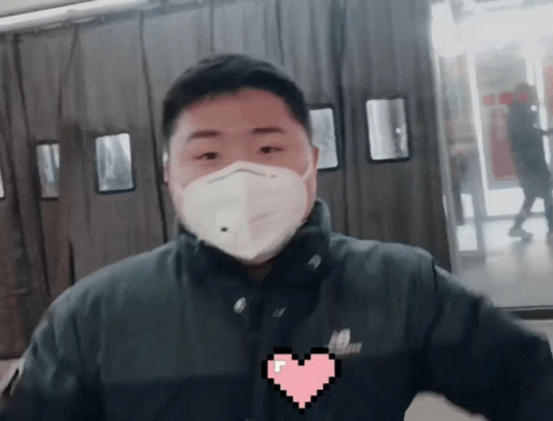 a guy in black shirt wearing a face mask