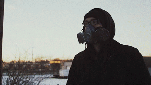 a man in gas mask and black jacket