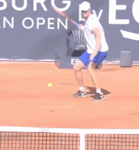 a man with an arm in the air swinging a tennis racket
