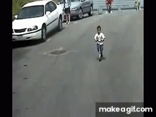 the camera has the person in white shirt riding his bicycle