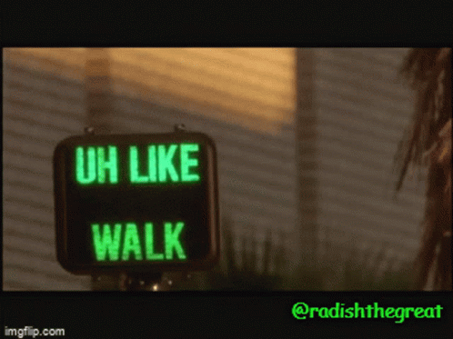 a green, illuminated sign with words saying u like walk