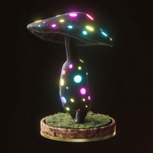 a glowing mushroom shaped object is lit up with different colored lights