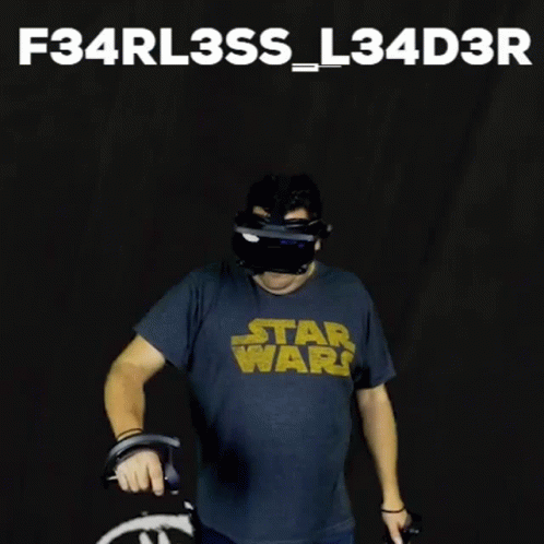 a man in a star wars t - shirt wearing a helmet and holding a wheel