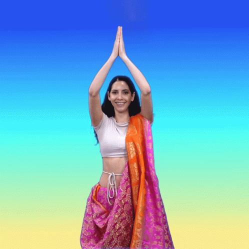 a woman in blue and pink with her hands above her head