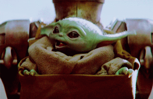 the child yoda is sitting in the carriage
