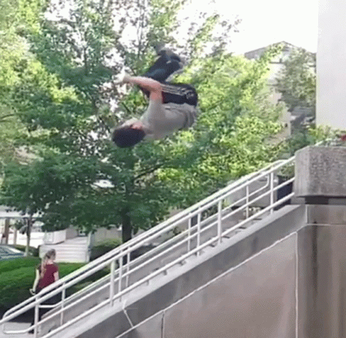 skateboarder doing tricks on cement ramp on cloudy day