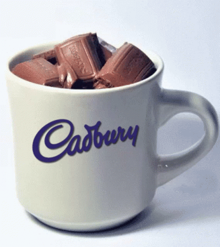 a coffee cup that has chocolates in it