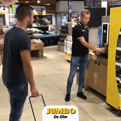 two men in a retail store looking at machines