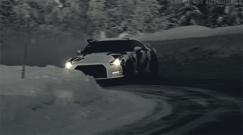 an automobile drives through the deep snow