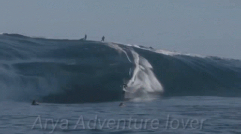 a group of people riding waves on top of each other