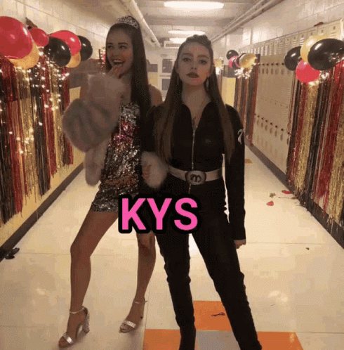 two girls posing for a po in a hallway