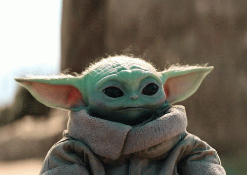 a baby yoda doll is wearing a robe