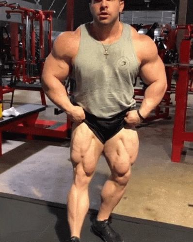 man in body - builder shorts posing for picture