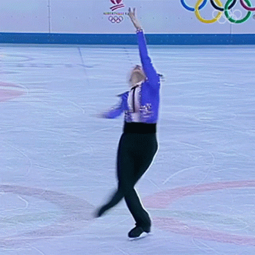 a figure is performing with the olympic rings