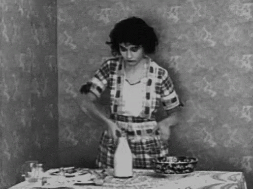 a woman preparing to cut into pieces of cake