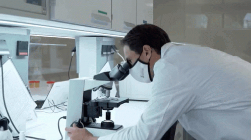 a man working in a lab with microscopes