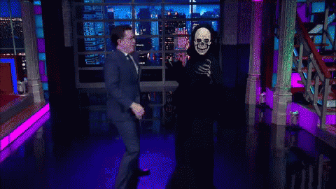 a tv monitor showing a skeleton wearing a suit and a mask