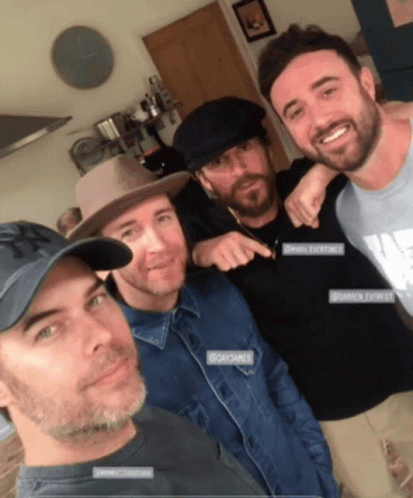five men all wearing hats taking a selfie