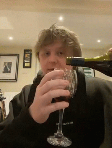 a man drinking out of a wine glass
