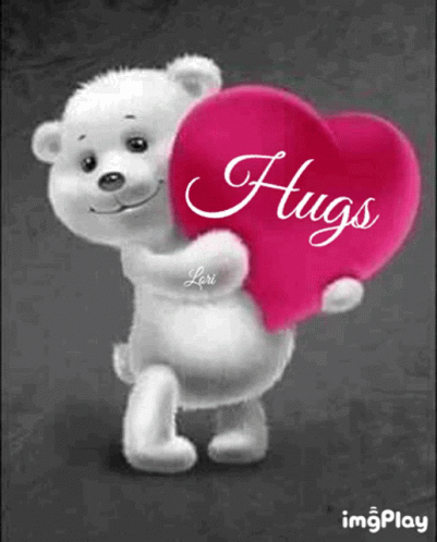 a teddy bear holding onto the message hugs