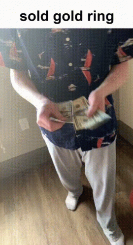 man in brown pants is holding a pile of money