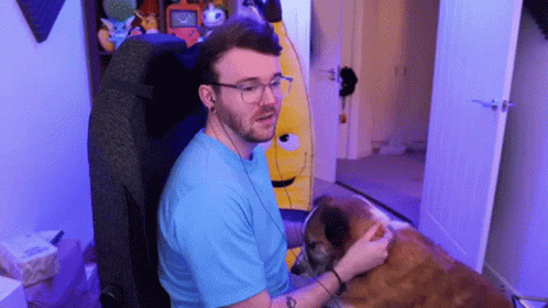 this is a man with glasses petting a dog