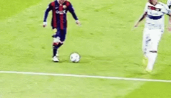 two soccer players kicking around a soccer ball