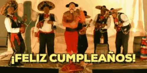 a group of musicians standing on a stage and a caption reads feliz cumpleanoos