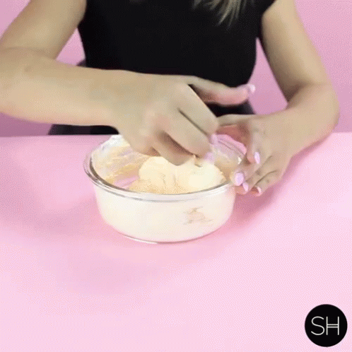 a woman is mixing soing in a bowl