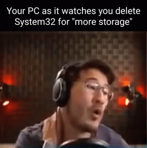 a man wearing headphones that is giving the word'your pc as it watches you delete system 32 for more storage