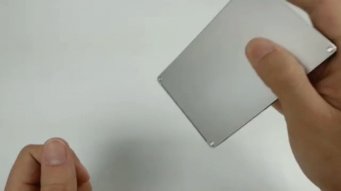 two hands holding an electronic card that contains micronitiles