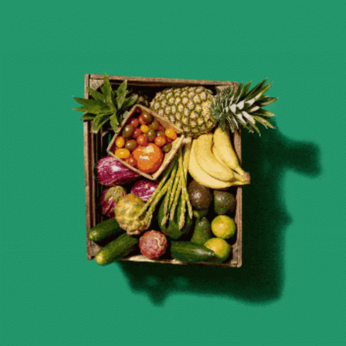 an arrangement of fruits in a wooden box