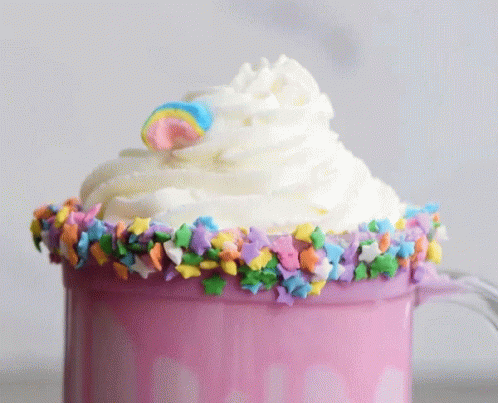 a cup with some frosting and a star decoration