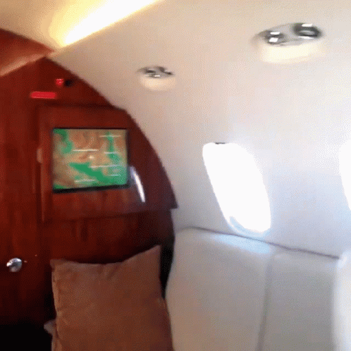 a tv screen is on the inside of an airplane